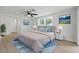 Serene bedroom featuring a plush bed, soft color accents, and bright natural light from a large window at 12601 Stone House Loop, Hudson, FL 34667
