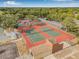 Aerial view showcasing community tennis courts and parking available for resident and guest convenience at 12601 Stone House Loop, Hudson, FL 34667