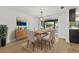 Bright dining room featuring a wooden table with seating for four and stylish decor and view to exterior at 12601 Stone House Loop, Hudson, FL 34667