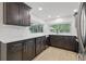 Contemporary kitchen with dark wood cabinetry, stainless steel appliances, and white subway tile backsplash at 12601 Stone House Loop, Hudson, FL 34667