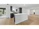 Open concept kitchen with stainless steel appliances, quartz countertops, and large center island at 12601 Stone House Loop, Hudson, FL 34667