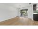 Bright living room featuring wood floors, recessed lighting, and sliding glass doors to outdoor patio at 12601 Stone House Loop, Hudson, FL 34667