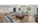 Bright, contemporary living room featuring stylish furniture, area rug, and natural light, creating a welcoming space at 12601 Stone House Loop, Hudson, FL 34667