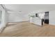 Open-concept living area featuring sleek flooring, dark cabinets, modern appliances, and natural light at 12601 Stone House Loop, Hudson, FL 34667
