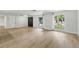 Spacious living room with sleek floors, large windows, and a modern entrance at 12601 Stone House Loop, Hudson, FL 34667