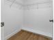 Walk-in closet with wood floors and wire shelving at 12601 Stone House Loop, Hudson, FL 34667