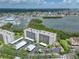 Scenic aerial view of a condo building with a marina, lush landscaping, and waterfront views at 1332 Pasadena S Ave # 503, South Pasadena, FL 33707