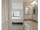 Bathroom with granite vanity and views into bedroom and out to waterfront at 1332 Pasadena S Ave # 503, South Pasadena, FL 33707