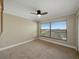 Comfortable carpeted bedroom with a ceiling fan and a large window offering views at 1332 Pasadena S Ave # 503, South Pasadena, FL 33707