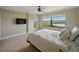 Relaxing bedroom with balcony access, a TV, and beautiful water views at 1332 Pasadena S Ave # 503, South Pasadena, FL 33707