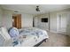Bedroom with ensuite bathroom, balcony, and mounted TV at 1332 Pasadena S Ave # 503, South Pasadena, FL 33707