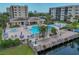 An inviting community pool and spa featuring lounge chairs and a deck overlooking the water at 1332 Pasadena S Ave # 503, South Pasadena, FL 33707
