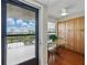 Eat-in kitchen area with balcony, featuring wood floors, built in cabinets and a ceiling fan at 1332 Pasadena S Ave # 503, South Pasadena, FL 33707