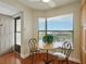Eat-in kitchen features a table and chairs in front of a window, with wood floors at 1332 Pasadena S Ave # 503, South Pasadena, FL 33707