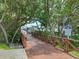 Picturesque walkway leading to boat docks surrounded by lush tropical greenery at 1332 Pasadena S Ave # 503, South Pasadena, FL 33707