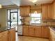 Kitchen with granite counters, wood cabinets, and a view of the pool at 1332 Pasadena S Ave # 503, South Pasadena, FL 33707