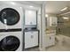 Laundry area adjacent to the bathroom with a stackable washer/dryer at 1332 Pasadena S Ave # 503, South Pasadena, FL 33707