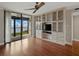 Living room showcasing built-in shelving, a ceiling fan, and sliding door access to a balcony at 1332 Pasadena S Ave # 503, South Pasadena, FL 33707