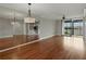 Bright living room featuring hardwood floors and sliding glass doors to a balcony at 1332 Pasadena S Ave # 503, South Pasadena, FL 33707