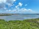 Picturesque coastal scene with blue sky and water and greenery in the foreground on a sunny day at 1332 Pasadena S Ave # 503, South Pasadena, FL 33707