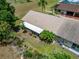 Aerial view features a screened-in porch, a lawn and greenery surrounding the home, and other nearby houses at 1349 New Bedford Dr # 6, Sun City Center, FL 33573