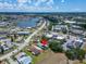 Aerial view of a community with a lake, and trees highlighting the property's desirable location at 1349 New Bedford Dr # 6, Sun City Center, FL 33573