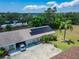 Aerial view of the home showcasing its solar panels, landscaping, and attached garage at 1349 New Bedford Dr # 6, Sun City Center, FL 33573