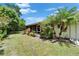 The backyard of home features decorative plants lining the back of the house and a screened in porch at 1349 New Bedford Dr # 6, Sun City Center, FL 33573