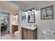 Bathroom featuring dual vanities, mirrors, and coastal decor for a relaxing experience at 1349 New Bedford Dr # 6, Sun City Center, FL 33573