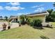 Close view of the front yard featuring an attached garage and diverse landscaping at 1349 New Bedford Dr # 6, Sun City Center, FL 33573