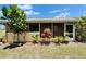 A rear exterior view of the home showing the screened in porch and decorative landscaping at 1349 New Bedford Dr # 6, Sun City Center, FL 33573