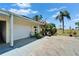 View of the home's exterior, featuring a well-maintained lawn and a one car attached garage at 1349 New Bedford Dr # 6, Sun City Center, FL 33573