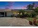 Charming single-story home with solar panels, lush landscaping, and attached garage under a beautiful twilight sky at 1349 New Bedford Dr # 6, Sun City Center, FL 33573