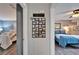 Hallway featuring coastal decor and views into bedrooms with beds and ceiling fans at 1349 New Bedford Dr # 6, Sun City Center, FL 33573