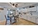 Bright kitchen with white cabinets, tile floor, eat-in dining area, and sliding glass doors to the outside at 1349 New Bedford Dr # 6, Sun City Center, FL 33573