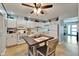 Efficient kitchen layout with white appliances, ample cabinet space, and cozy dining table for casual meals at 1349 New Bedford Dr # 6, Sun City Center, FL 33573