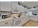 Clean kitchen with white cabinets, appliances, and lots of countertop space at 1349 New Bedford Dr # 6, Sun City Center, FL 33573