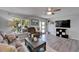 Well-lit living room featuring wood-look flooring, comfortable seating, and a large window at 1349 New Bedford Dr # 6, Sun City Center, FL 33573