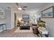 Inviting living room with wood floors, a ceiling fan, and comfortable seating for relaxing and entertaining at 1349 New Bedford Dr # 6, Sun City Center, FL 33573