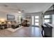 Bright and inviting living room with neutral tones, wood-look floors, and a large window, creating a serene atmosphere at 1349 New Bedford Dr # 6, Sun City Center, FL 33573
