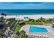 Beautiful aerial view of complex including the pool, tropical landscaping and private beach at 1480 Gulf Blvd # 109, Clearwater Beach, FL 33767