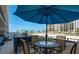 Enjoy beach views from this balcony, which features a table for four and additional patio seating at 1480 Gulf Blvd # 109, Clearwater Beach, FL 33767
