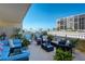 Relaxing balcony featuring comfortable outdoor seating with ocean views and tropical plants at 1480 Gulf Blvd # 109, Clearwater Beach, FL 33767