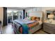 Cozy bedroom featuring a comfortable bed, sliding glass doors to a balcony, and stylish decor at 1480 Gulf Blvd # 109, Clearwater Beach, FL 33767