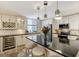 Modern kitchen with stainless steel appliances, granite countertops, and a wine refrigerator at 1480 Gulf Blvd # 109, Clearwater Beach, FL 33767