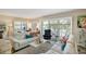 Bright living room with white sofas, colorful pillows, plantation shutters, and stylish decor at 1480 Gulf Blvd # 109, Clearwater Beach, FL 33767
