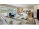 Open-concept living room flowing into the kitchen, featuring modern furnishings and natural light at 1480 Gulf Blvd # 109, Clearwater Beach, FL 33767