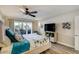 Comfortable bedroom with modern furniture, decorative wall art and balcony access at 1480 Gulf Blvd # 109, Clearwater Beach, FL 33767