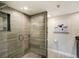 Modern shower featuring decorative tile walls, glass door, and rainfall shower head at 1480 Gulf Blvd # 109, Clearwater Beach, FL 33767