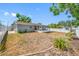 The exterior features a fenced backyard, landscaping, and a screened patio at 14884 Cromwell Dr, Clearwater, FL 33764